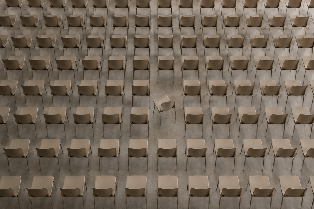 Rows of identical chairs with one chair subtly turned, illustrating how small visual differences immediately draw attention and shape perception.