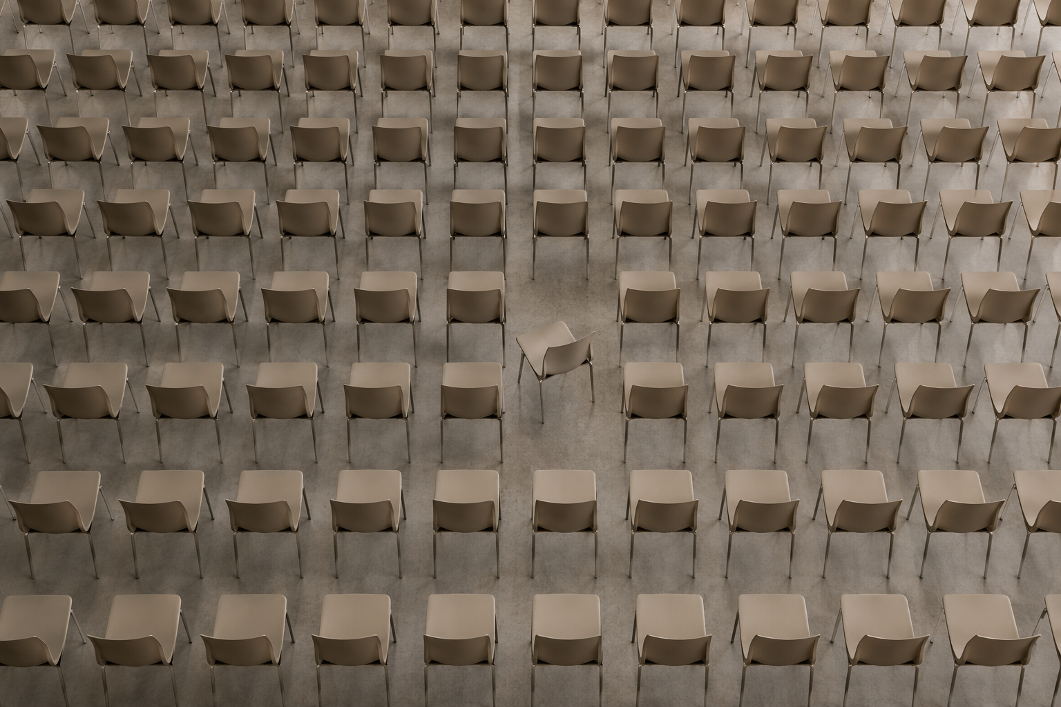 Rows of identical chairs with one chair subtly turned, illustrating how small visual differences immediately draw attention and shape perception.