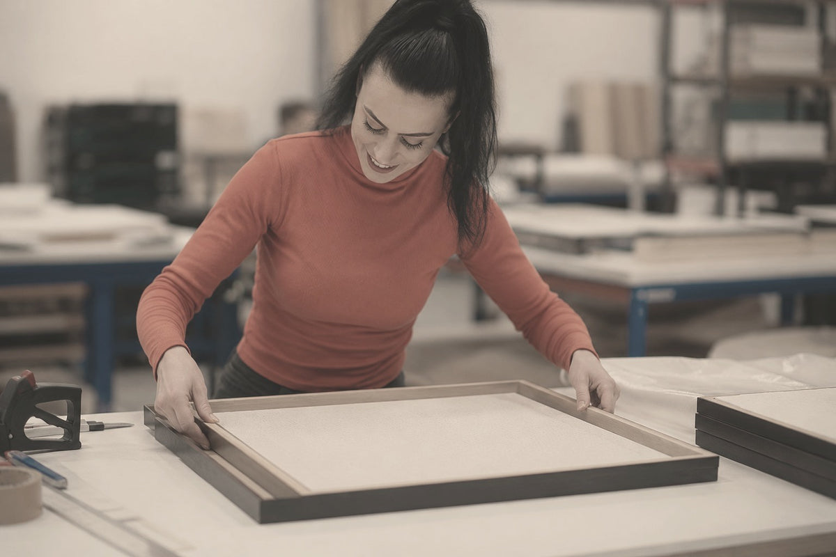 An ODE artwork being carefully framed and prepared in the studio